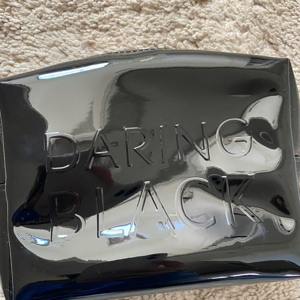 This is a Saint Laurent (YSL) Daring Black makeup bag.